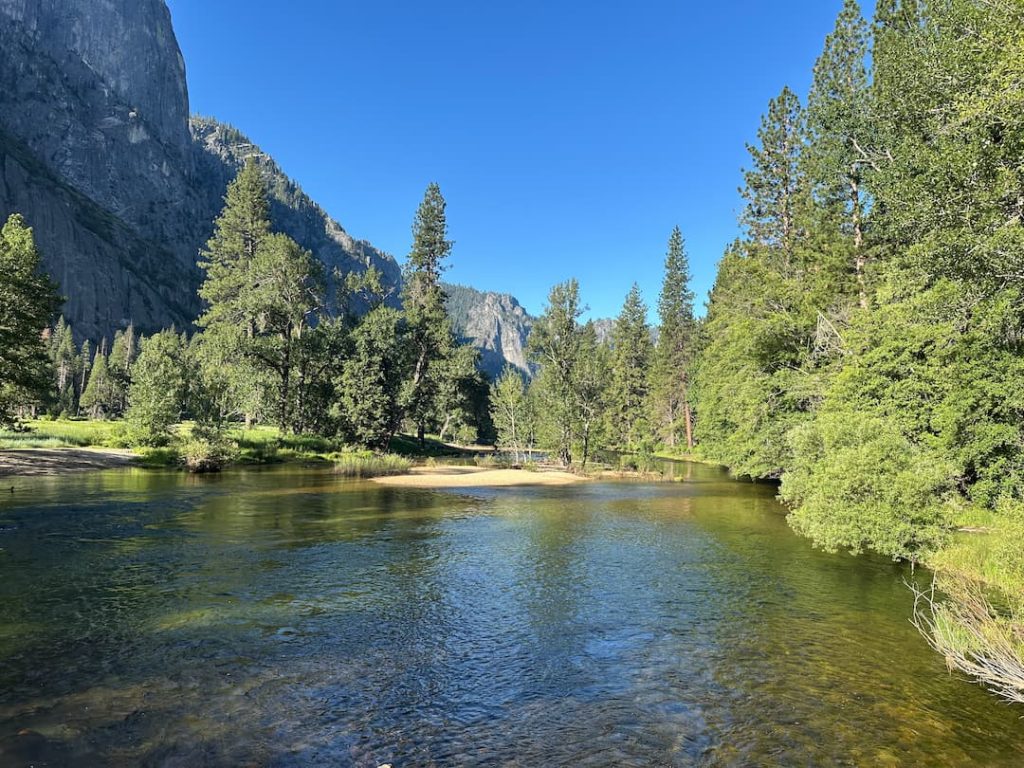 Photo de la Merced River à Yosemite National Park prise depuis un fond avec les falaises de granit en fond